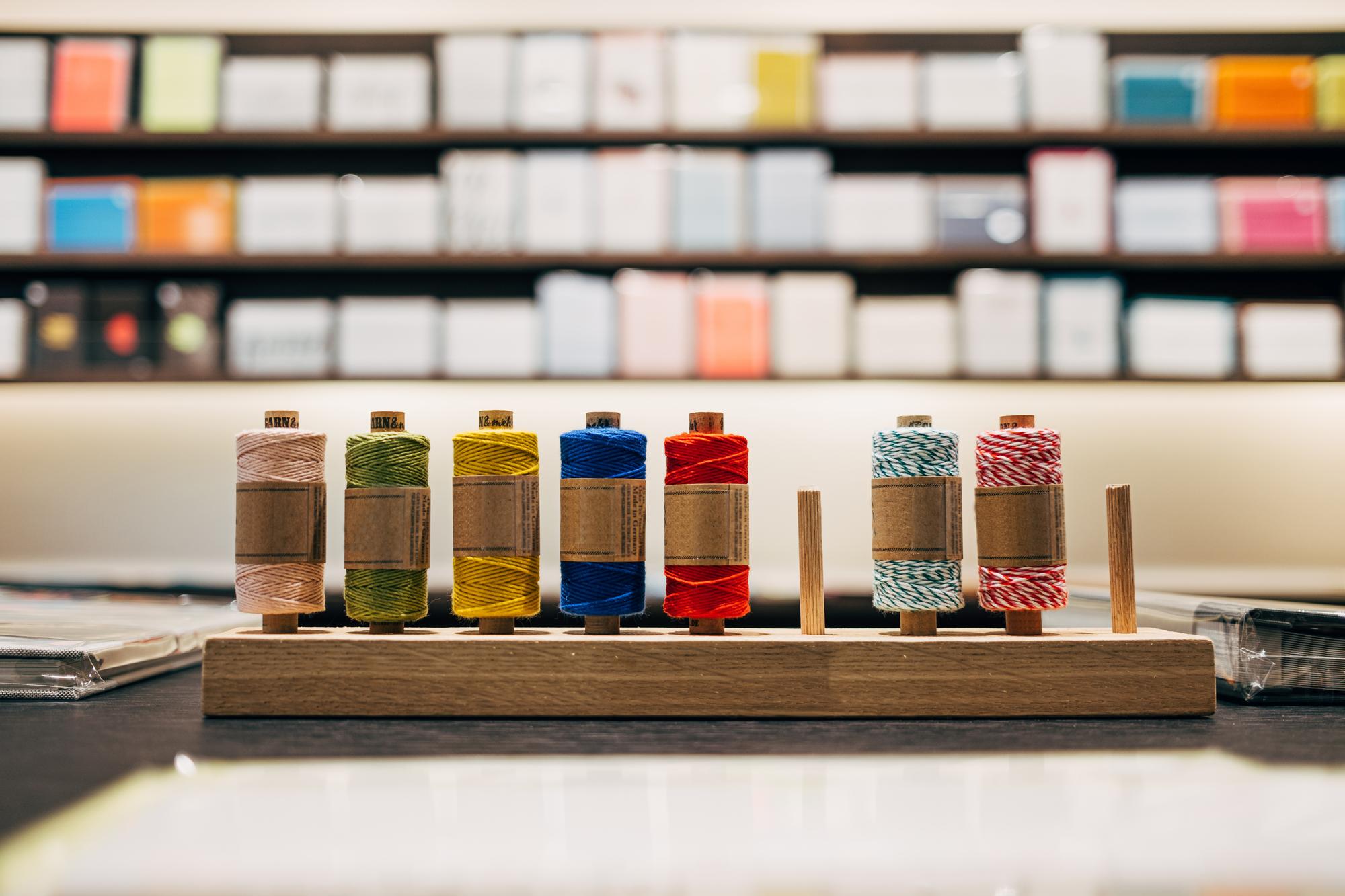 studio workshop with embroidery machines and organized threads